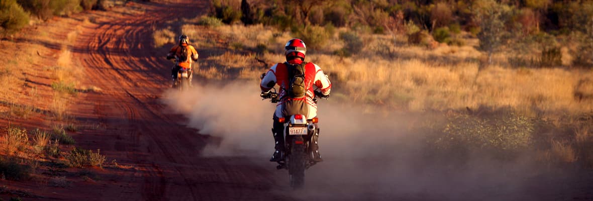 Two motorcyclists ride through the NT
