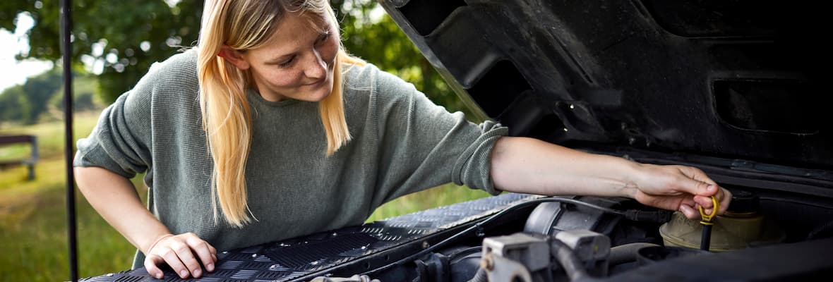 Woman on the phone with broken down car