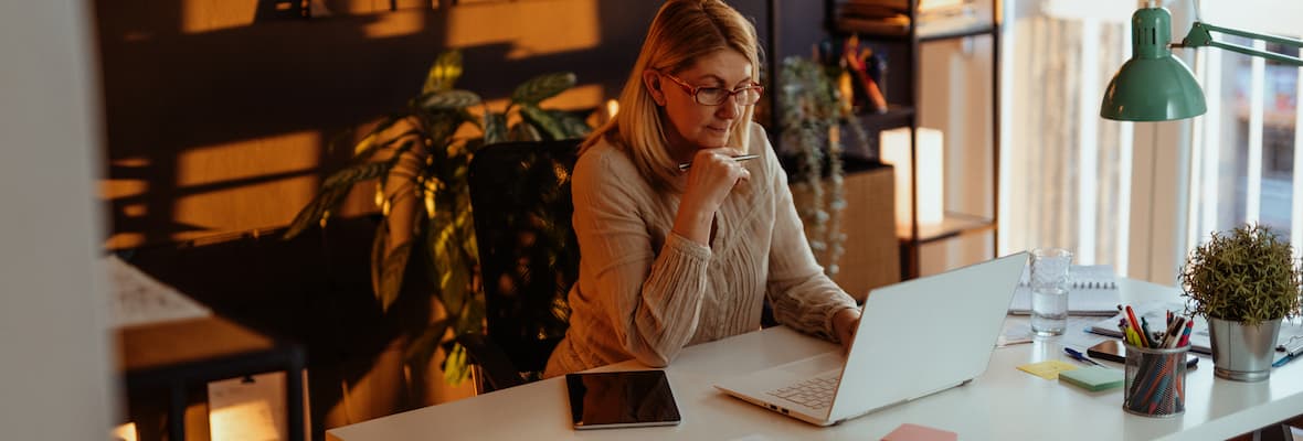 woman checking computer at desk