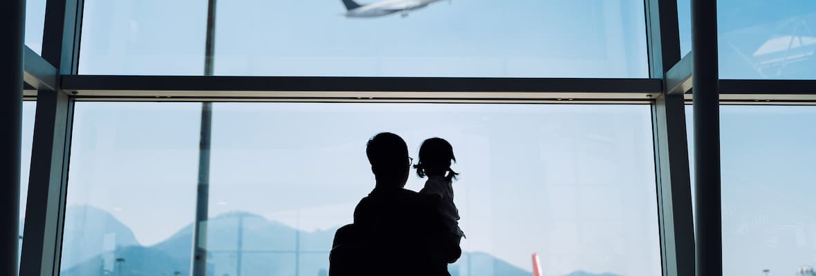 Dad and daughter watching plane at airport