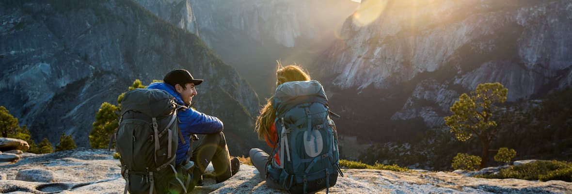 young hiking couple sitting in yosemite national park