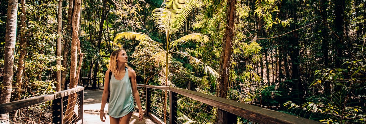 Young woman walks through woodland area on Fraser Island