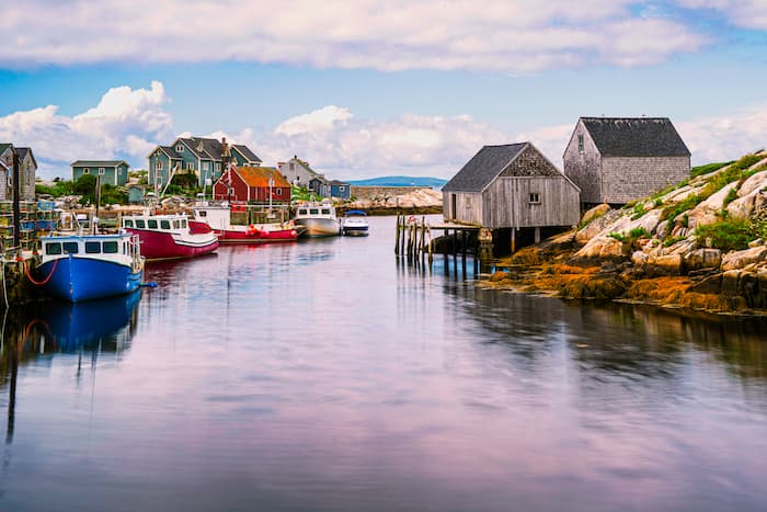 Peggy's Cove Seascape with moored boats and weathered seaside shacks in Nova Scotia, Canada.