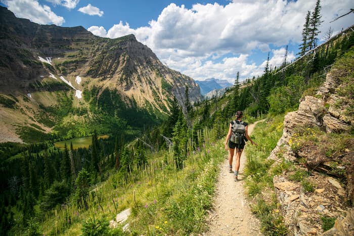 A young woman hikes through wilderness in the Canadian Rockies.