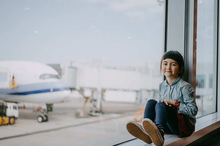 Girl on a window sill at airport